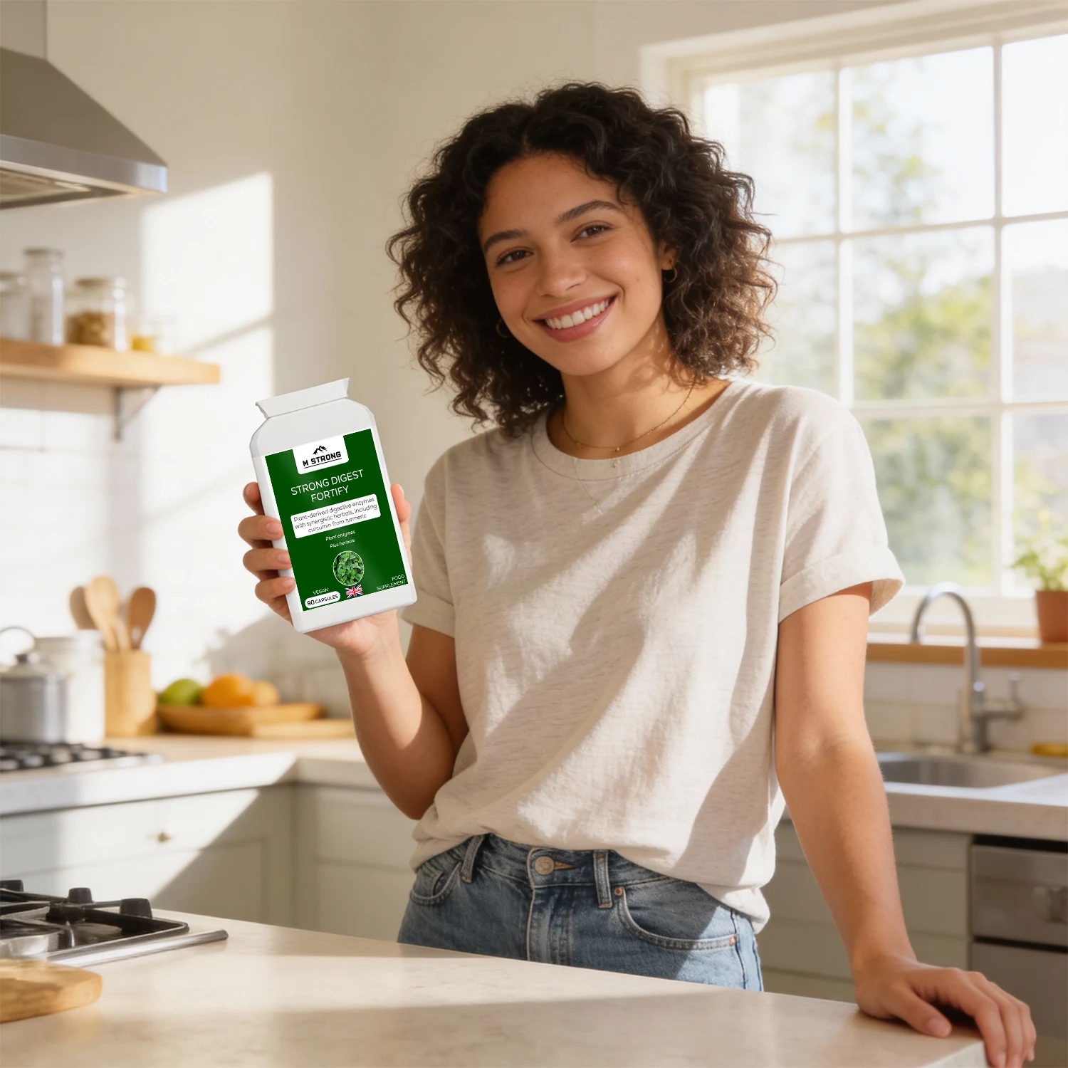 Woman holding STRONG DIGEST FORTIFY digestive enzyme M Strong supplement in a home kitchen, supporting daily digestion