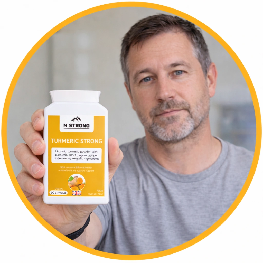 Middle-aged man holding a bottle of M STRONG Turmeric Strong supplement with a neutral expression, showing the label clearly inside a branded orange circle frame.